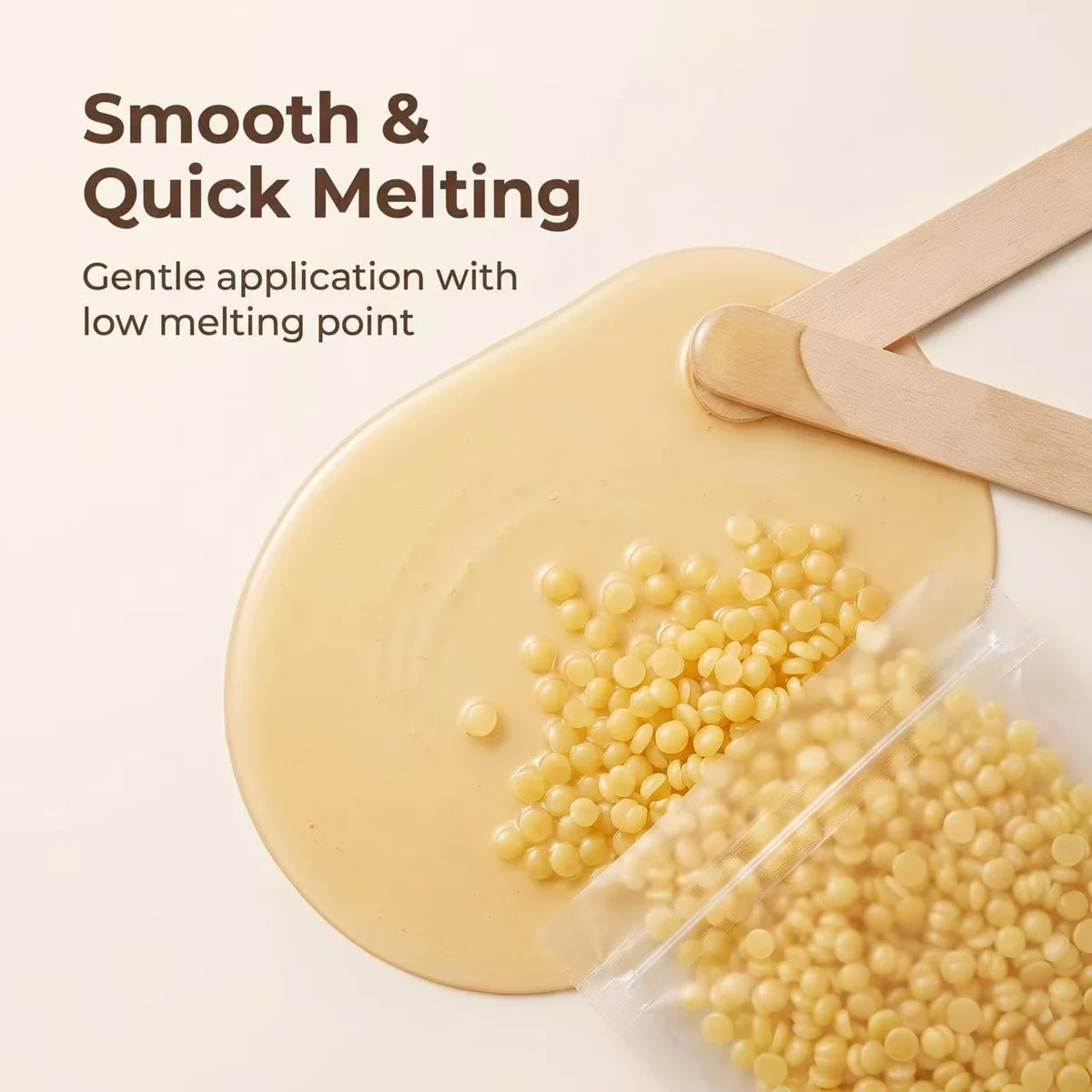 Hard wax beads melting into a smooth pool, with a wooden spatula alongside