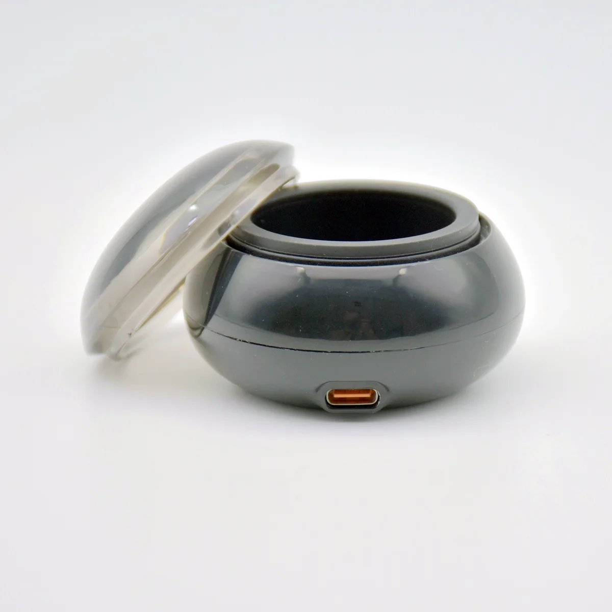 PW6 mini wax heater in gloss black with transparent dome cover open, Type-C port visible