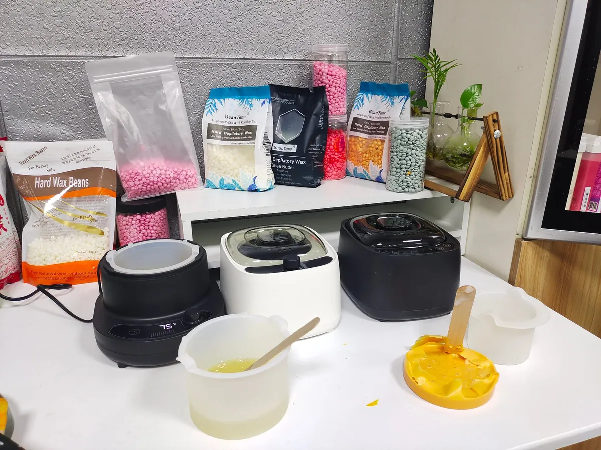 BeauTome wax heater family with private-label hard wax bags in the studio